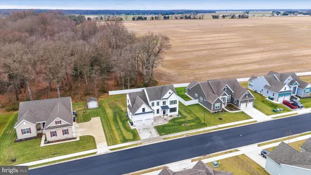 a living room with furniture dining table and a flat screen tv