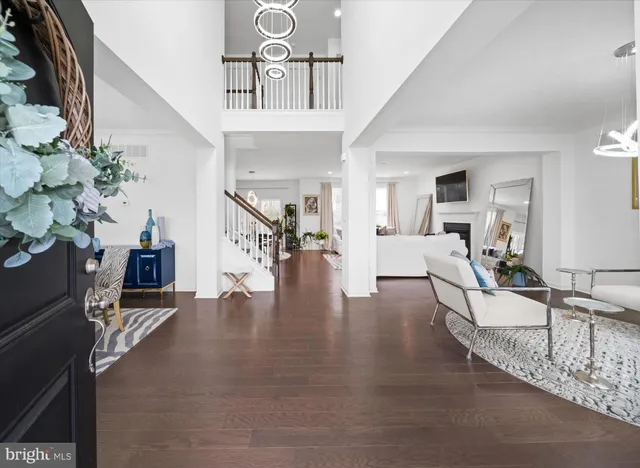 a living room with furniture a potted plant and a table