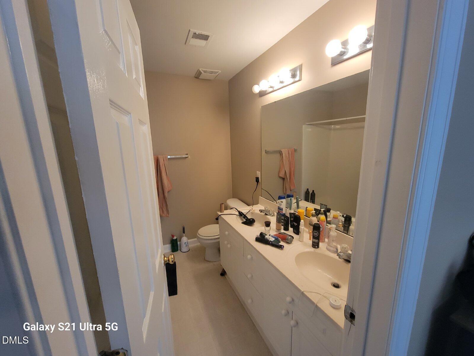 929 Morreene Road, Unit B26 Durham, NC 27705 - Photo 3 of 6 a bathroom with a sink a mirror and a bath tub