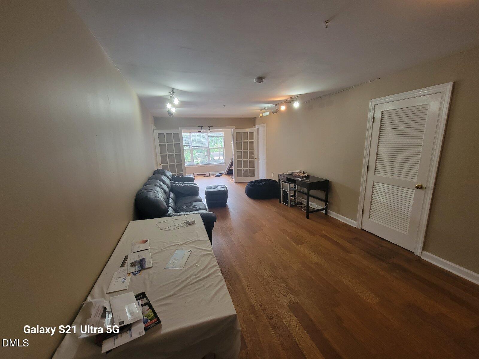 929 Morreene Road, Unit B26 Durham, NC 27705 - Photo 6 of 6 a room with furniture and a wooden floor