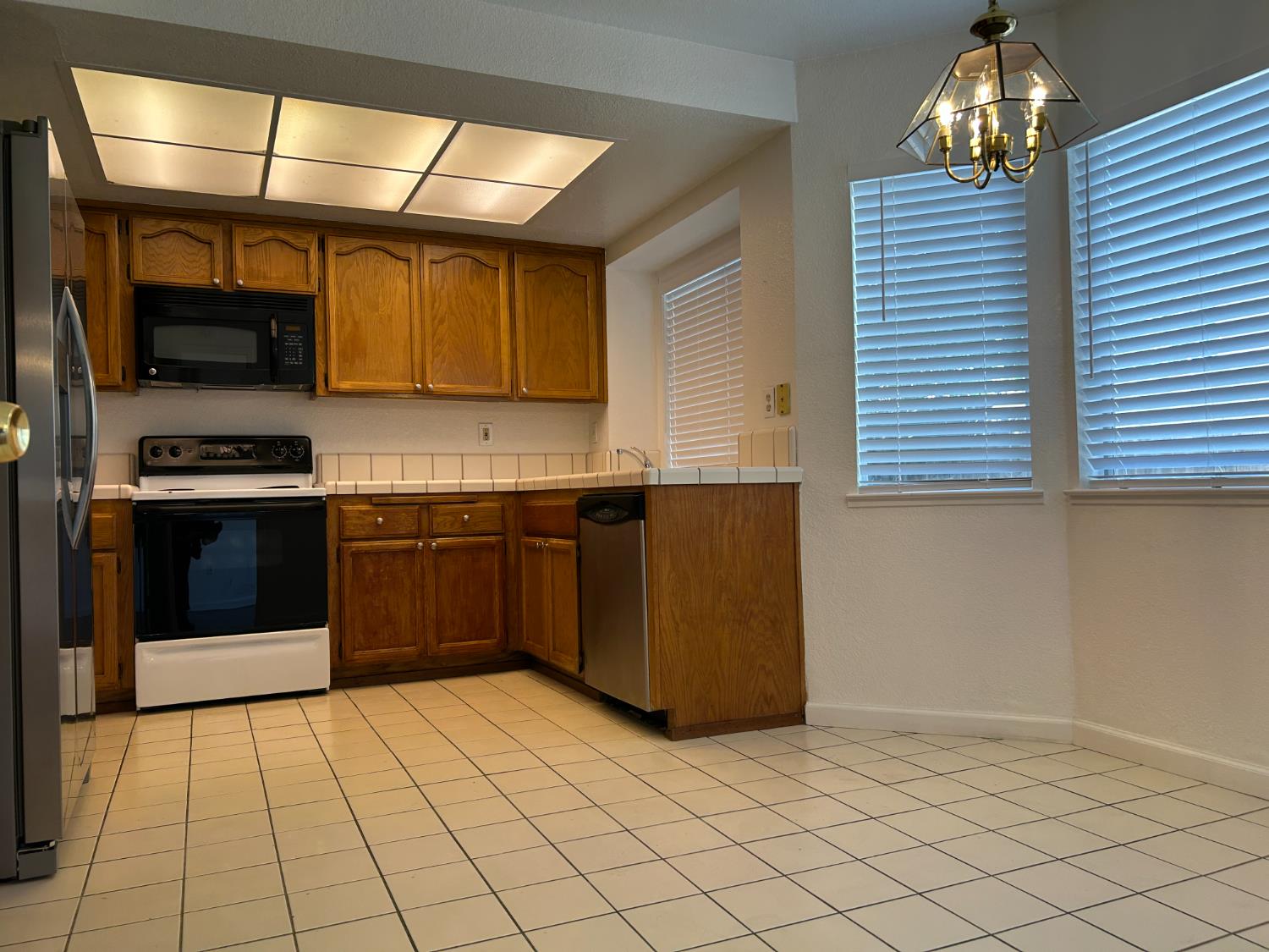 1981 West Kavanagh Avenue Tracy, CA 95376 - Photo 4 of 21 a kitchen with stainless steel appliances granite countertop a stove a sink and a microwave