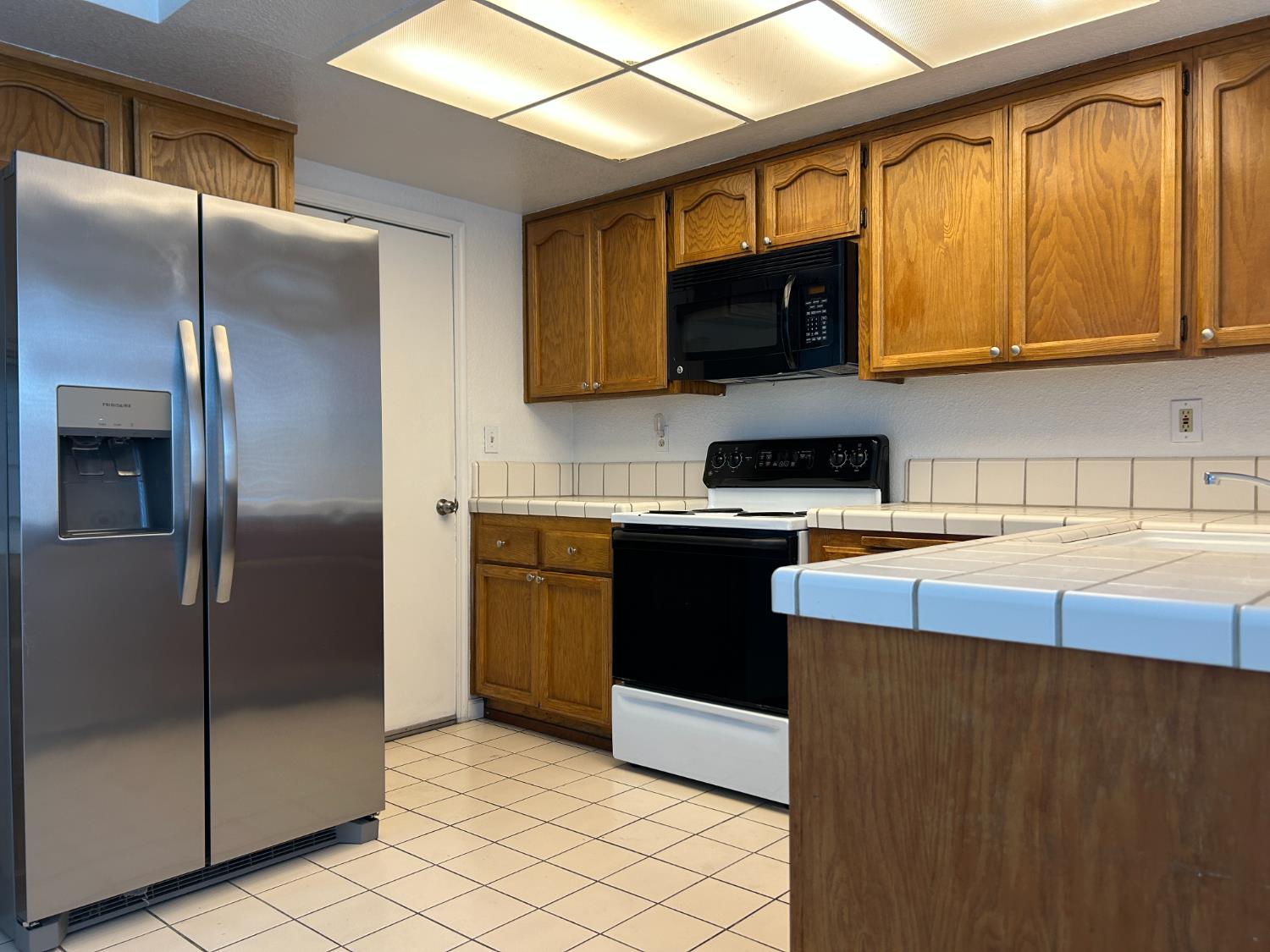 1981 West Kavanagh Avenue Tracy, CA 95376 - Photo 5 of 21 a kitchen with stainless steel appliances granite countertop a refrigerator a sink a stove top oven and a dishwasher