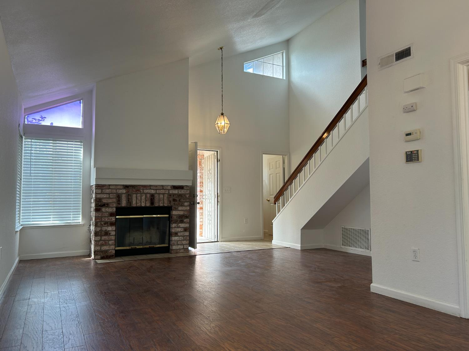 1981 West Kavanagh Avenue Tracy, CA 95376 - Photo 7 of 21 an empty room with wooden floor fire place and windows