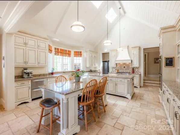 a kitchen with kitchen island granite countertop counter space a sink appliances and cabinets