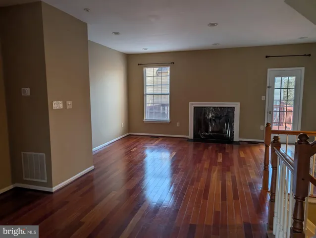 an empty room with mirror and windows