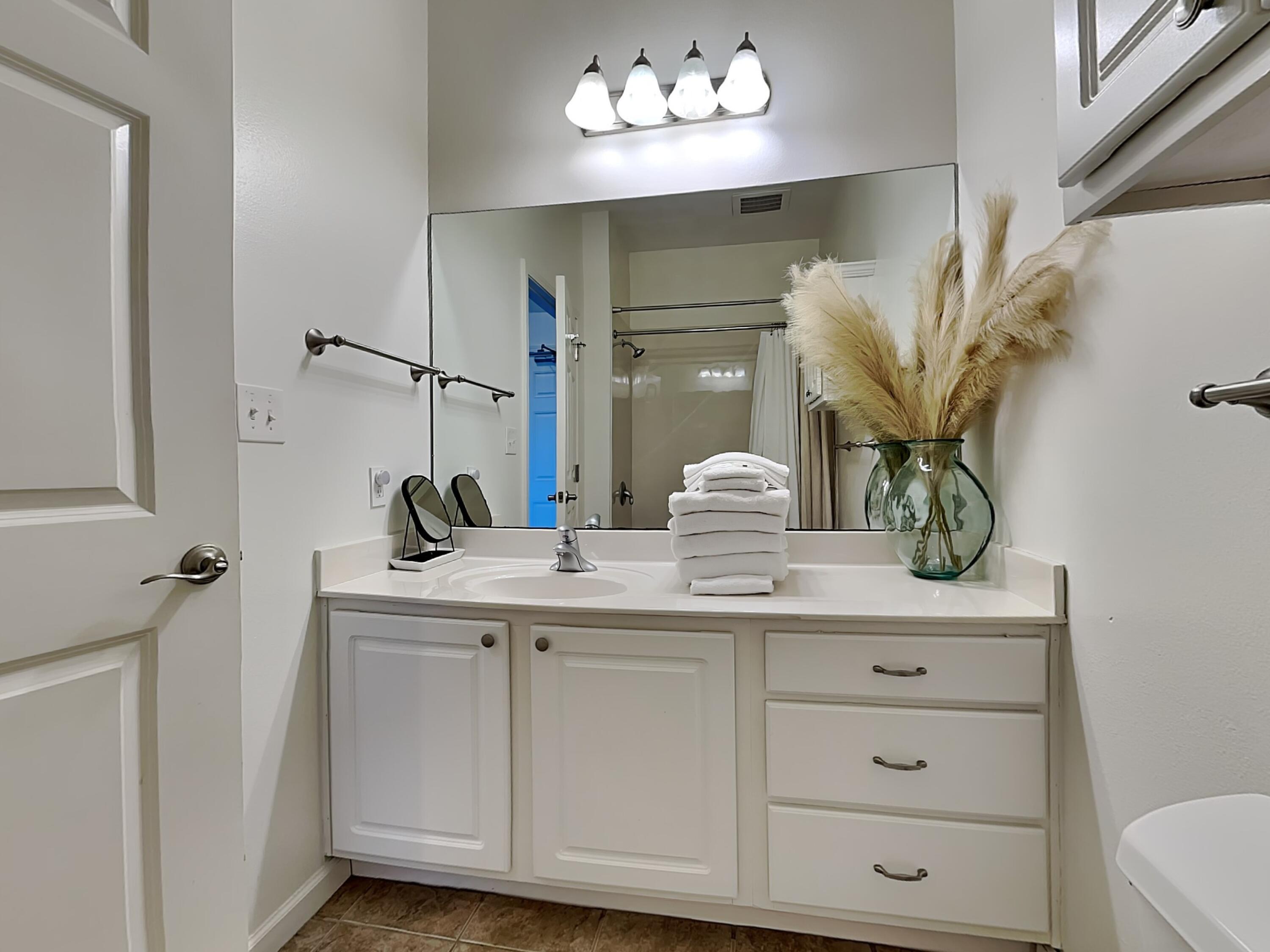 9955 East County Highway 30A, Unit 303 Inlet Beach, FL 32461 - Photo 12 of 17 a bathroom with a sink vanity and a mirror