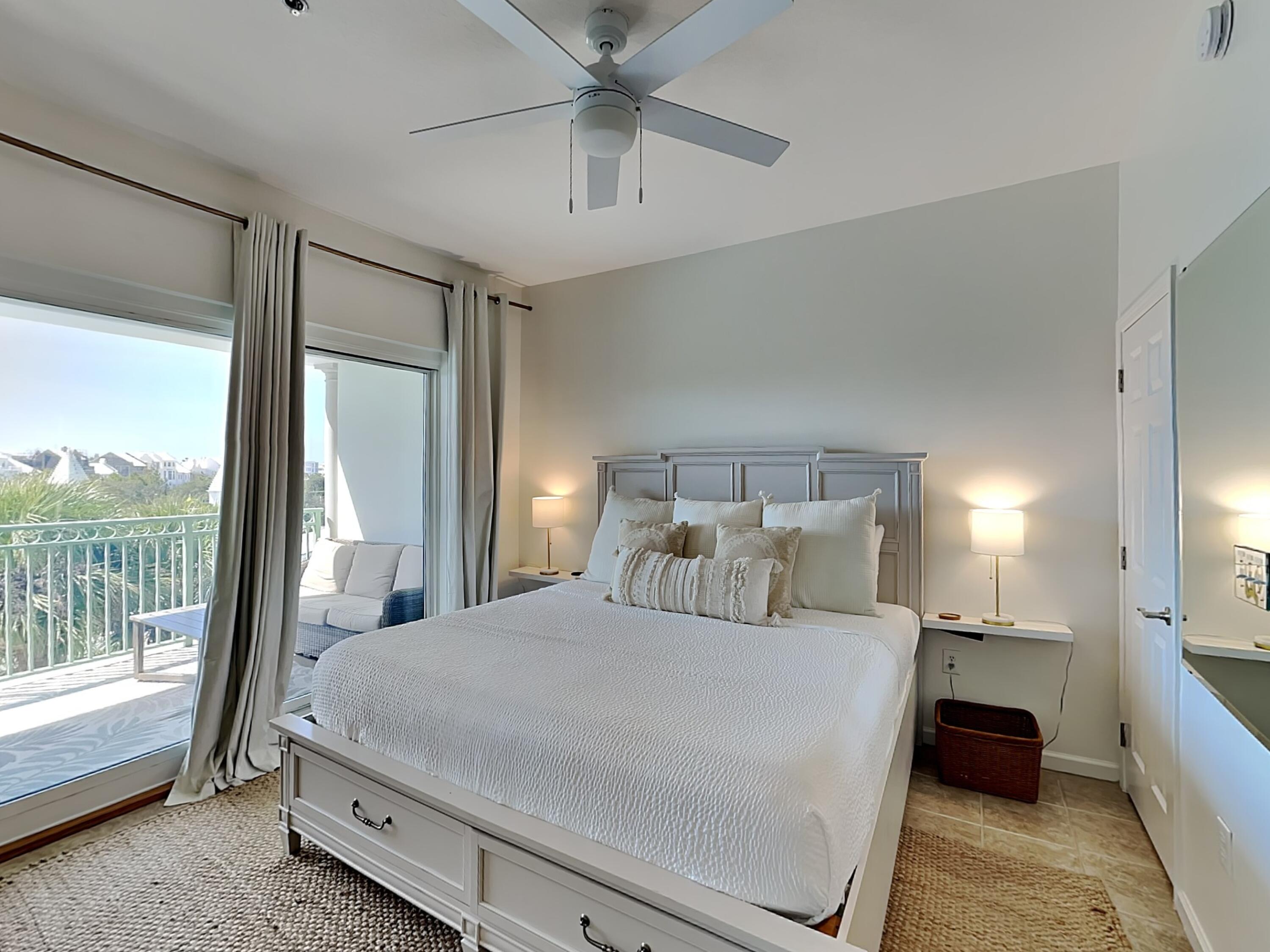9955 East County Highway 30A, Unit 303 Inlet Beach, FL 32461 - Photo 3 of 17 a bedroom with a large bed and a chandelier fan
