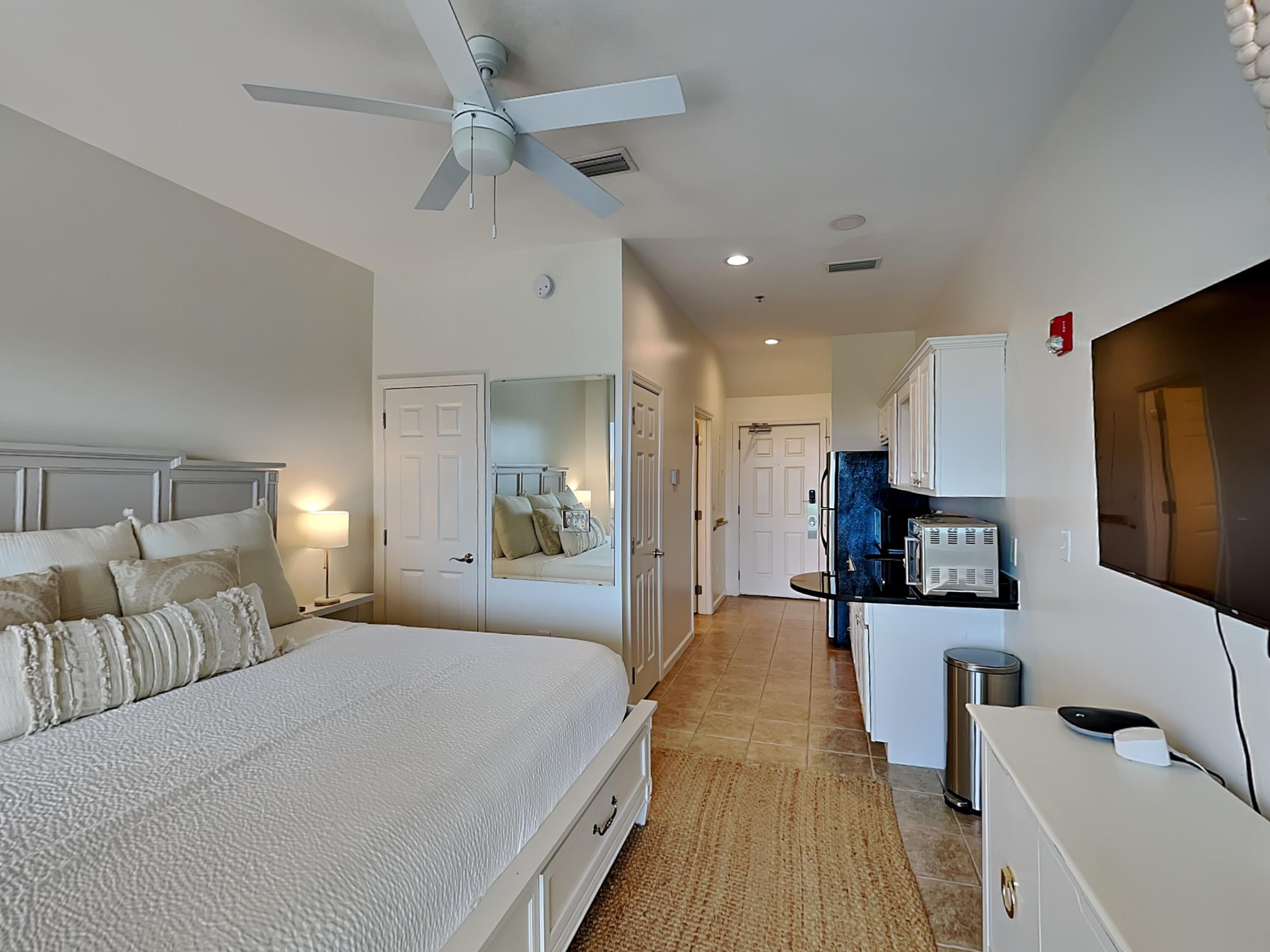 9955 East County Highway 30A, Unit 303 Inlet Beach, FL 32461 - Photo 4 of 17 a spacious bedroom with a bed and a flat screen tv