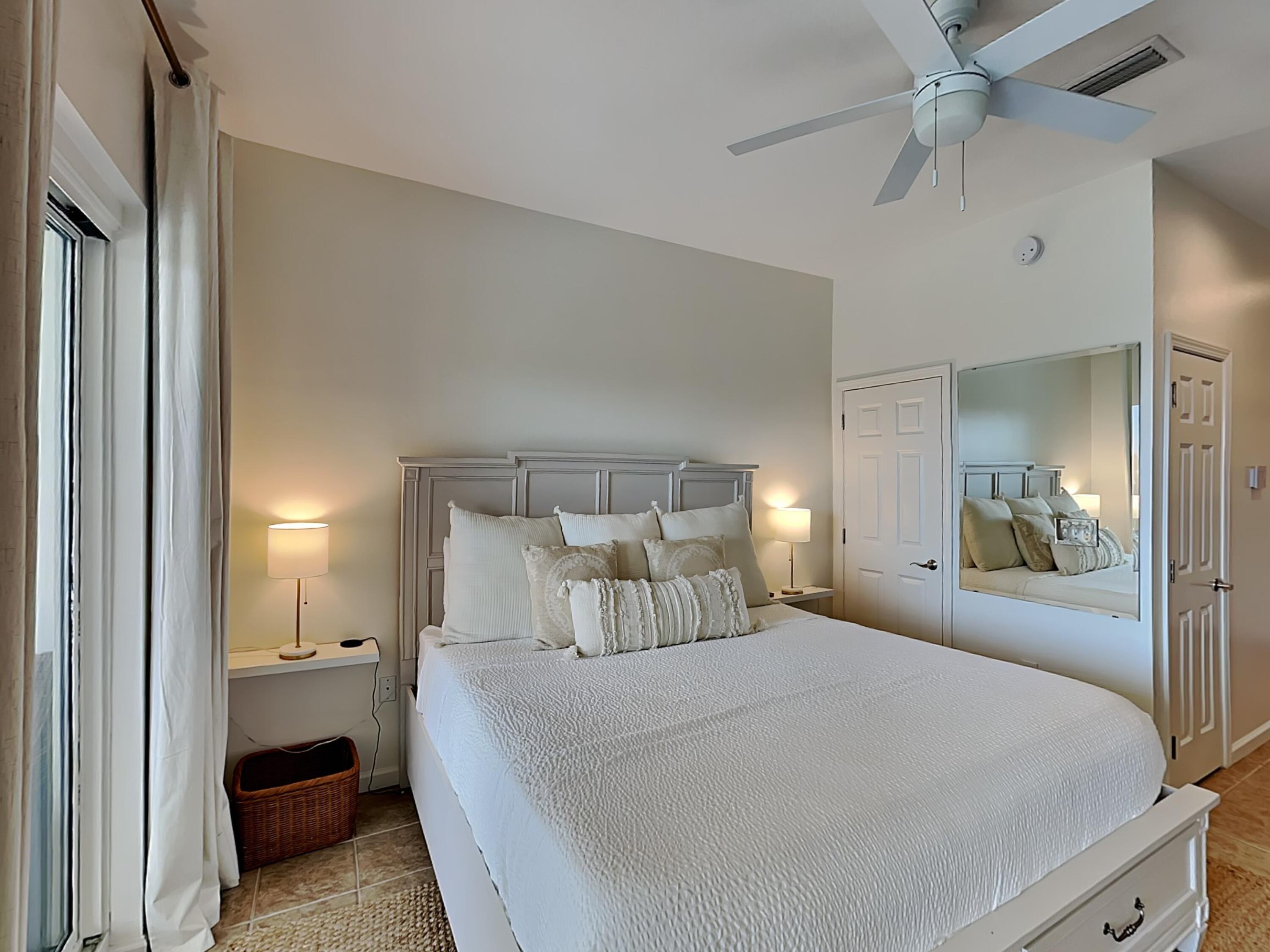 9955 East County Highway 30A, Unit 303 Inlet Beach, FL 32461 - Photo 9 of 17 a bedroom with a bed and glass walk in closet