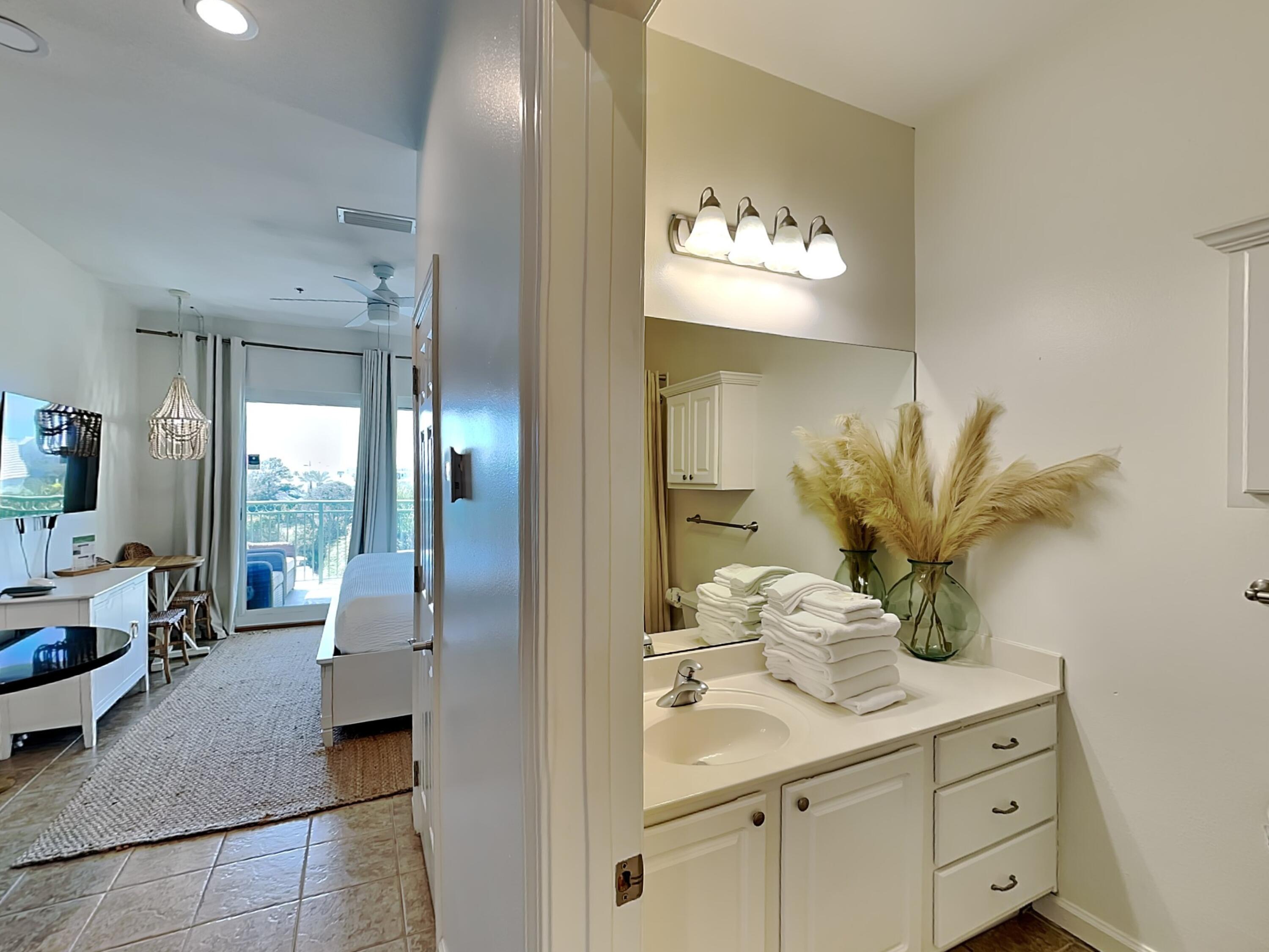 9955 East County Highway 30A, Unit 303 Inlet Beach, FL 32461 - Photo 10 of 17 a view of spacious bathroom with a potted plant on the counter and sink