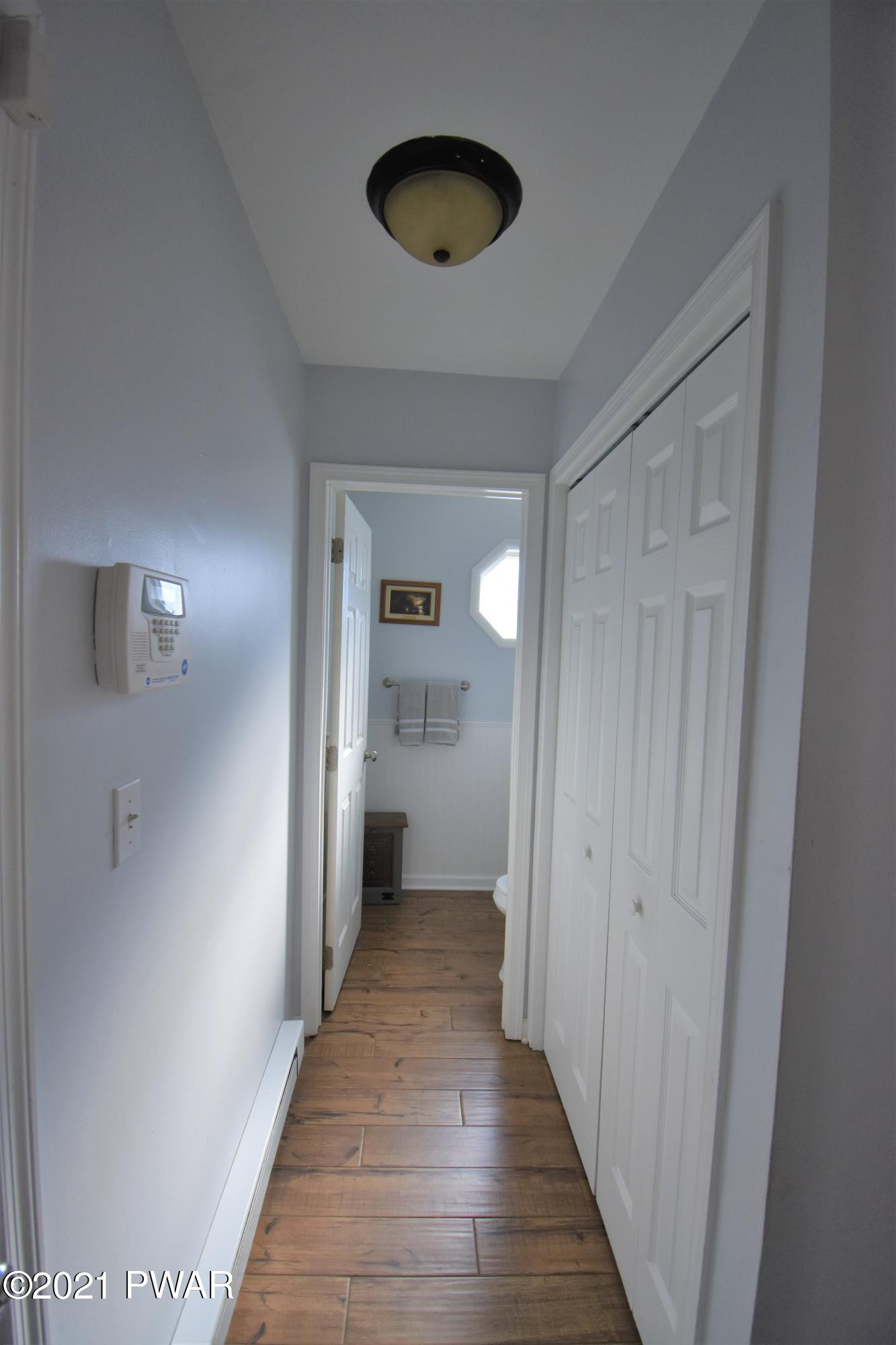 244 Fox Road Dingmans Ferry, PA 18328 - Photo 16 of 31 a view of a hallway with wooden floor