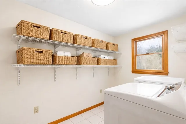 a spacious bedroom with a bed and wooden floor