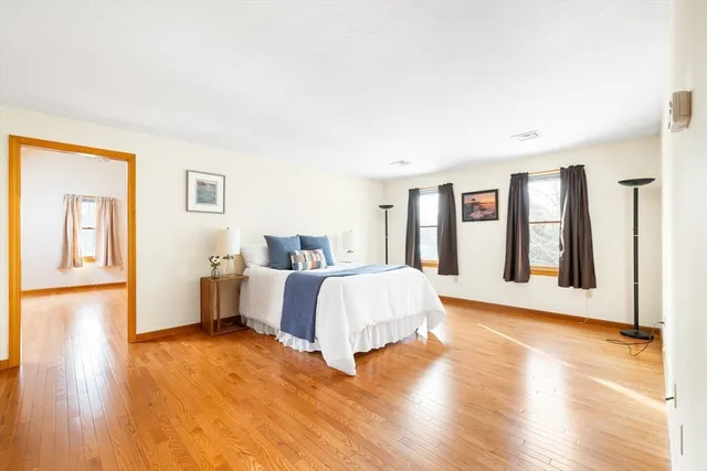 a spacious bedroom with a bed and a table