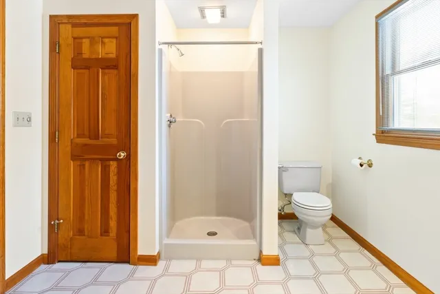 a bedroom with a bed and a night stand