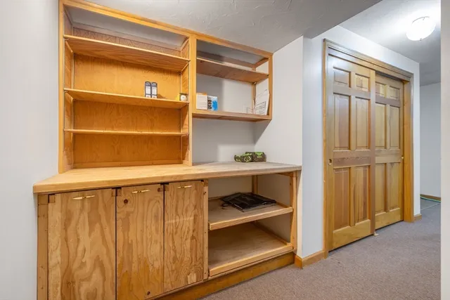 a view of backyard with large trees and wooden fence