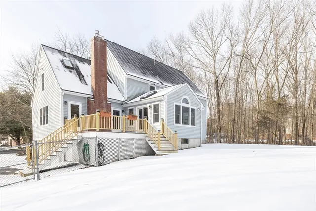 a view of a white house with snow in the background