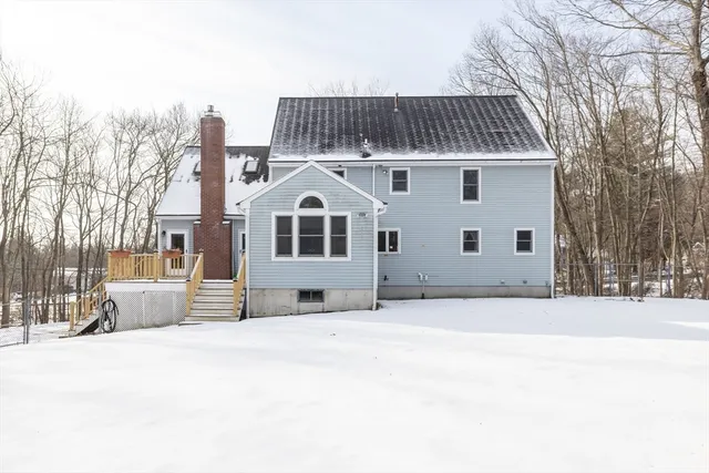 a view of house with a yard covered with snow