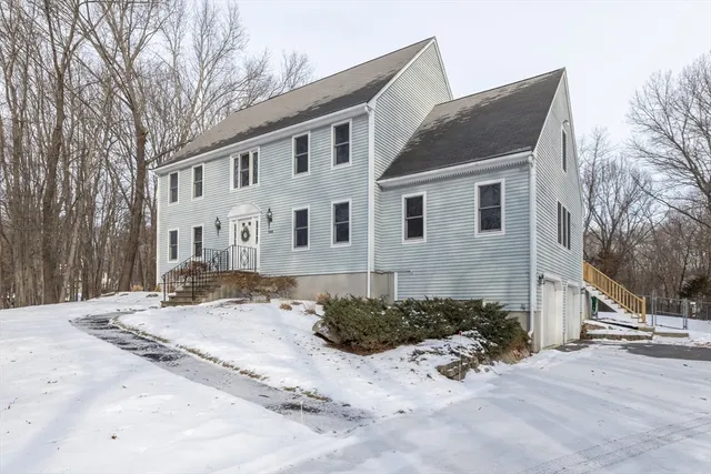 a view of large house with a snow on the road
