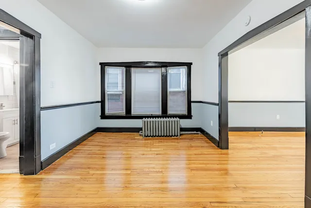 a view of empty room with floor to ceiling window