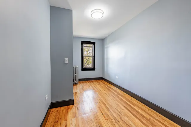 a view of room with window and hardwood floor