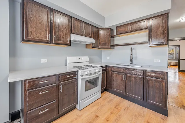 a kitchen with stainless steel appliances granite countertop a stove and a sink