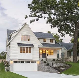 a front view of a house with a tree in it