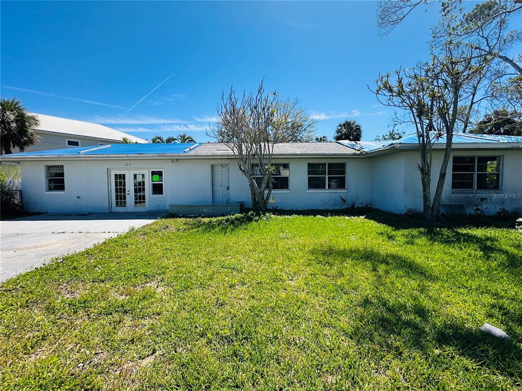 a front view of house with yard and green space