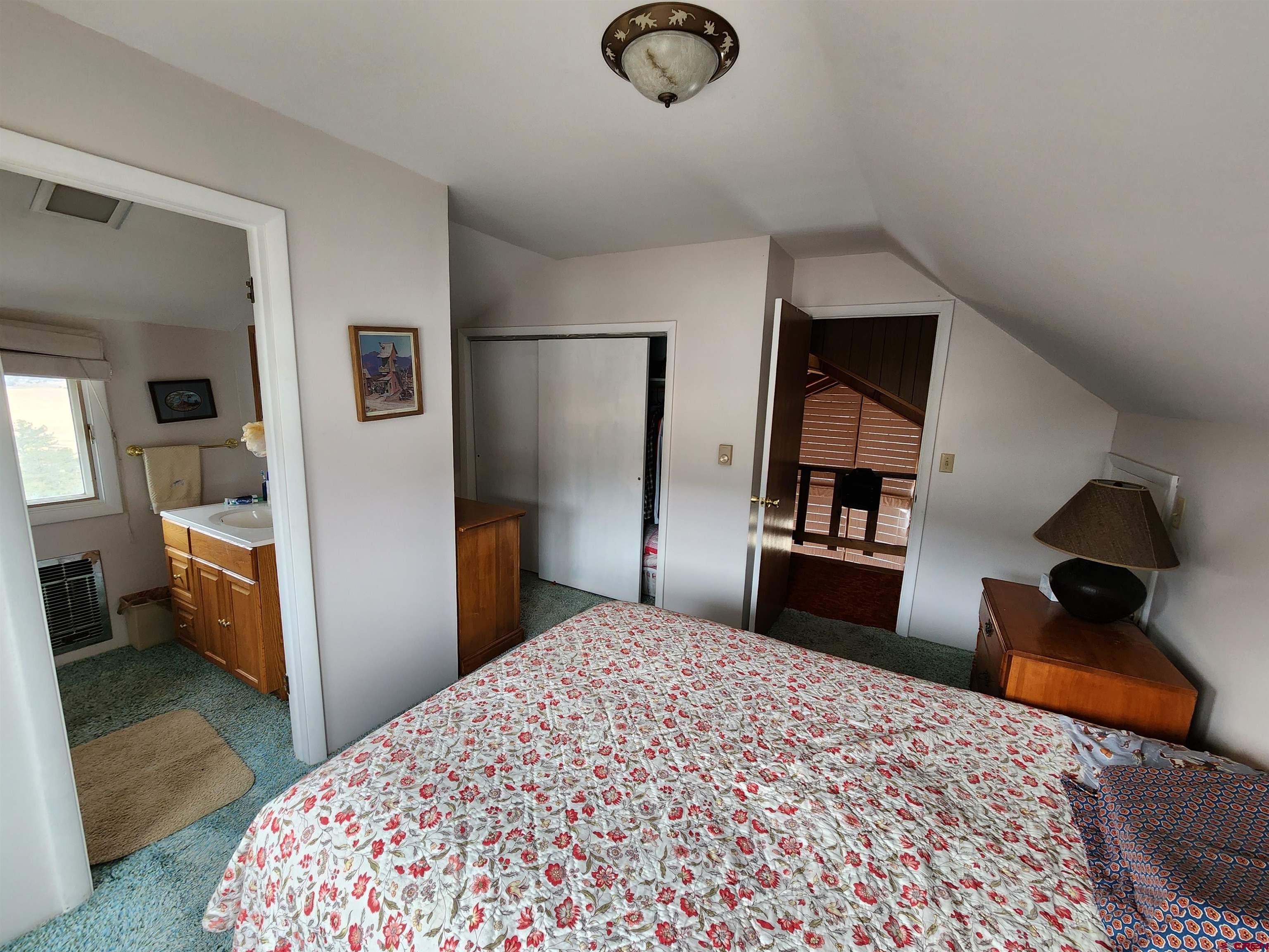 Tbd County Rd LL56 Villa Grove, CO 81155 - Photo 14 of 24 a bedroom with a bed and a large mirror