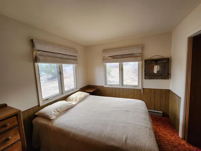 a bedroom with a bed and a window