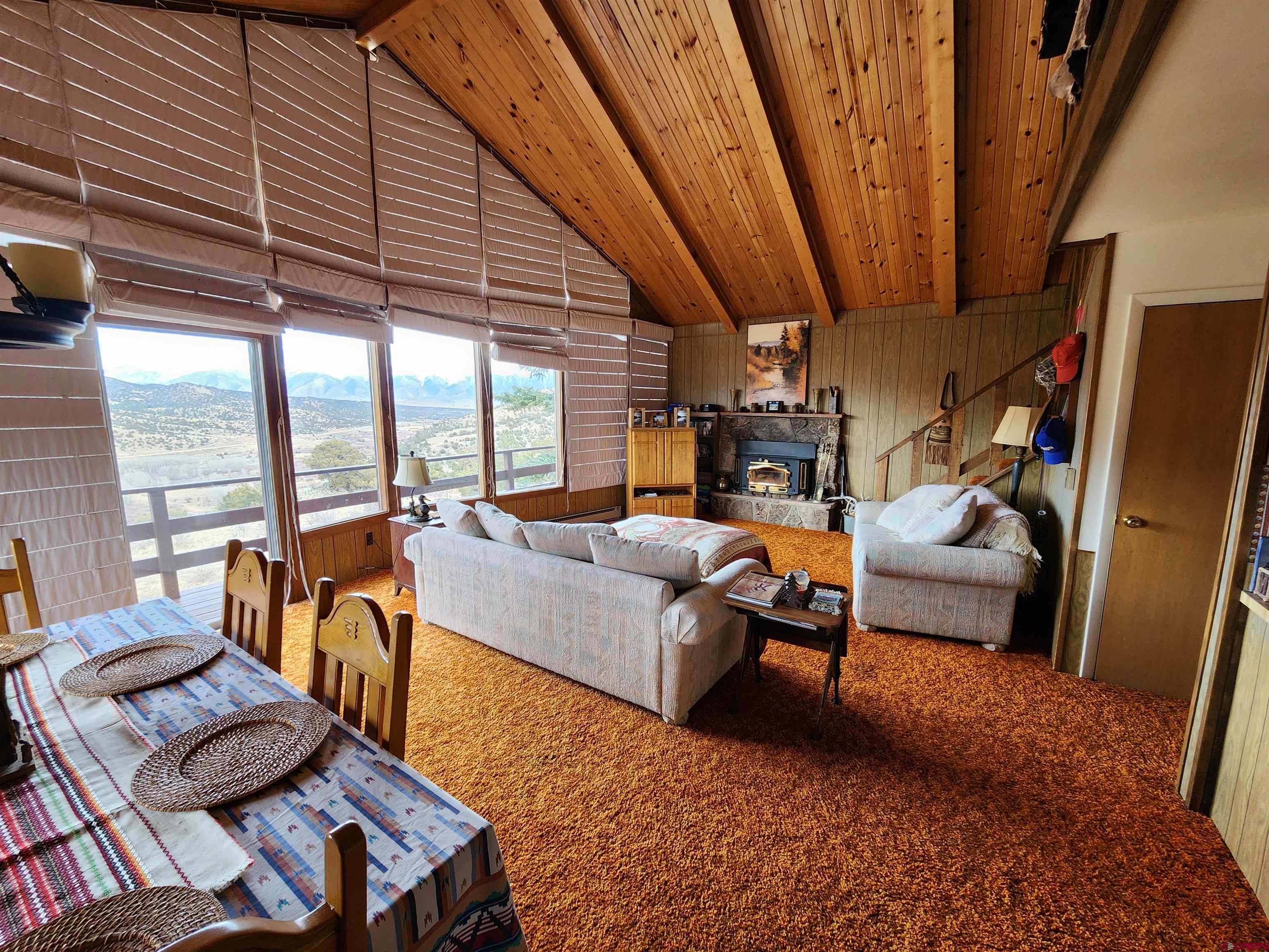 Tbd County Rd LL56 Villa Grove, CO 81155 - Photo 18 of 24 a living room with furniture and a floor to ceiling window