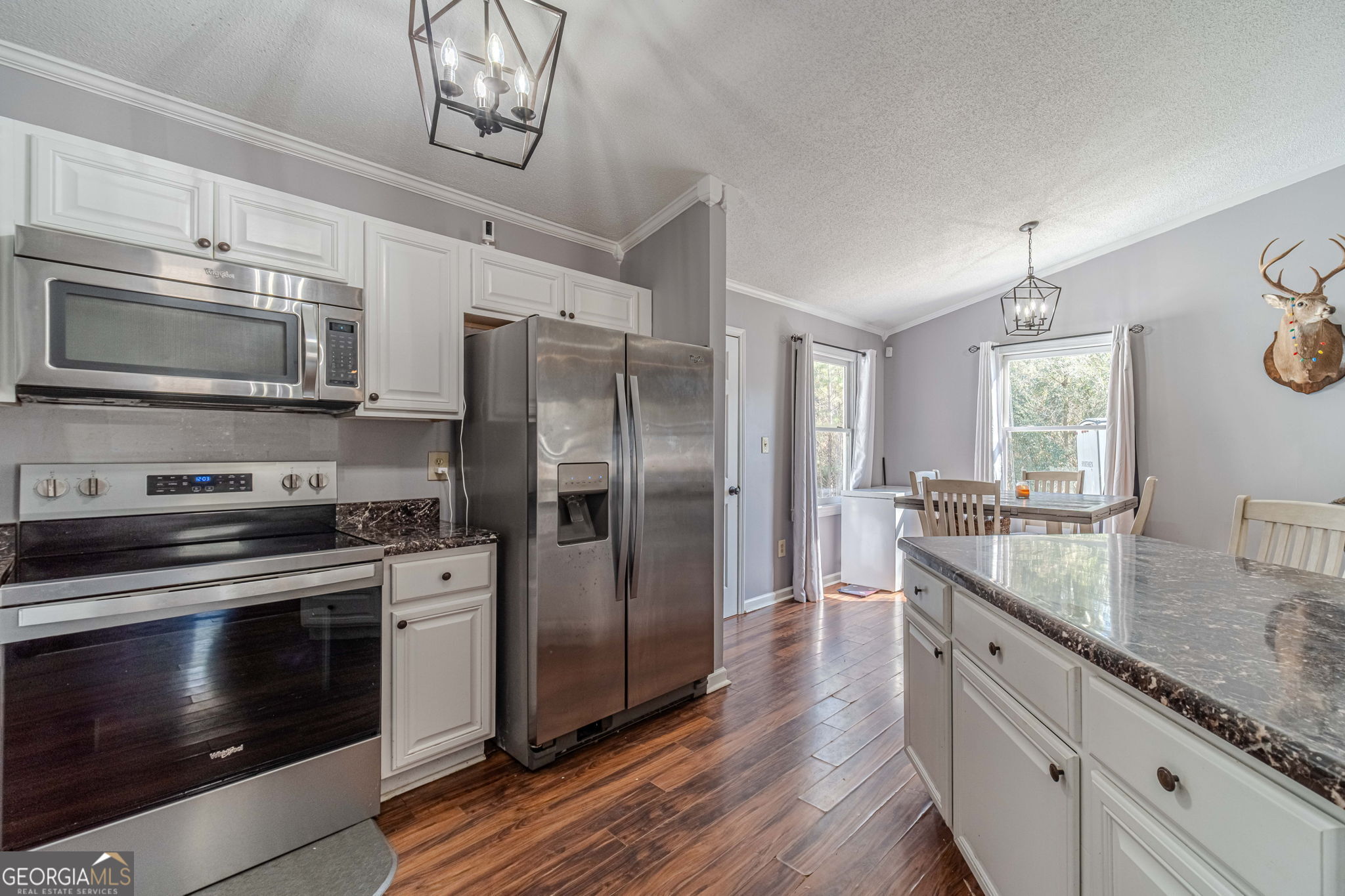 2811 High Shoals Road Good Hope, GA 30641 - Photo 11 of 37 a kitchen with stainless steel appliances granite countertop a stove a sink dishwasher a refrigerator and a microwave oven with wooden floor