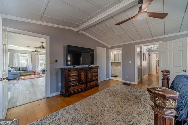 a bedroom with furniture and a flat screen tv