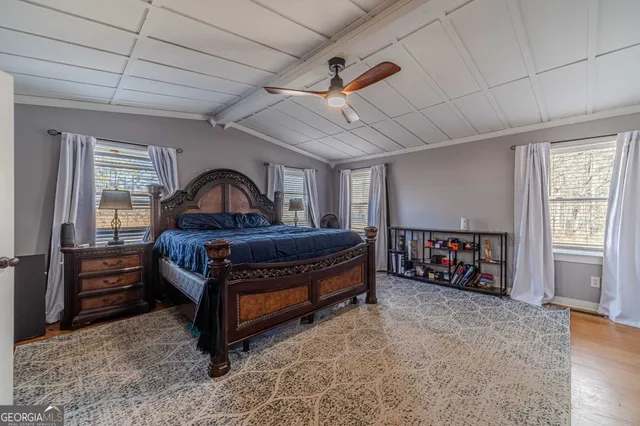 a en suite bathroom with a granite countertop sink and a large mirror