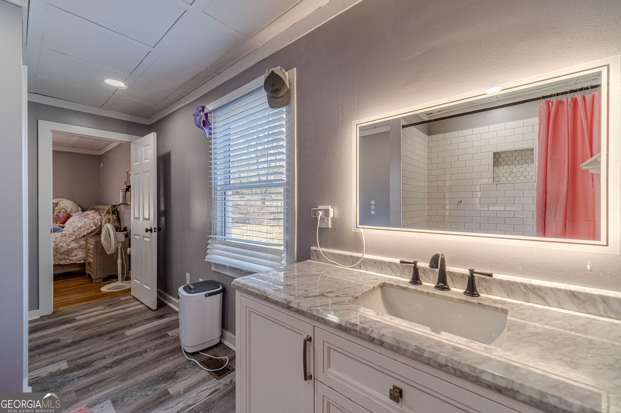 2811 High Shoals Road Good Hope, GA 30641 - Photo 17 of 37 a en suite bathroom with a granite countertop sink and a large mirror