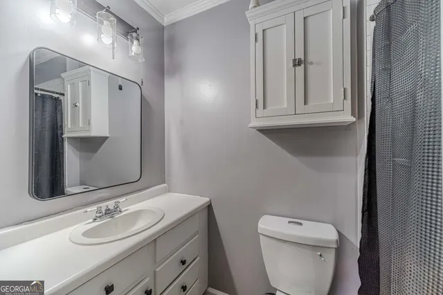 a bedroom with bed and a wooden floor