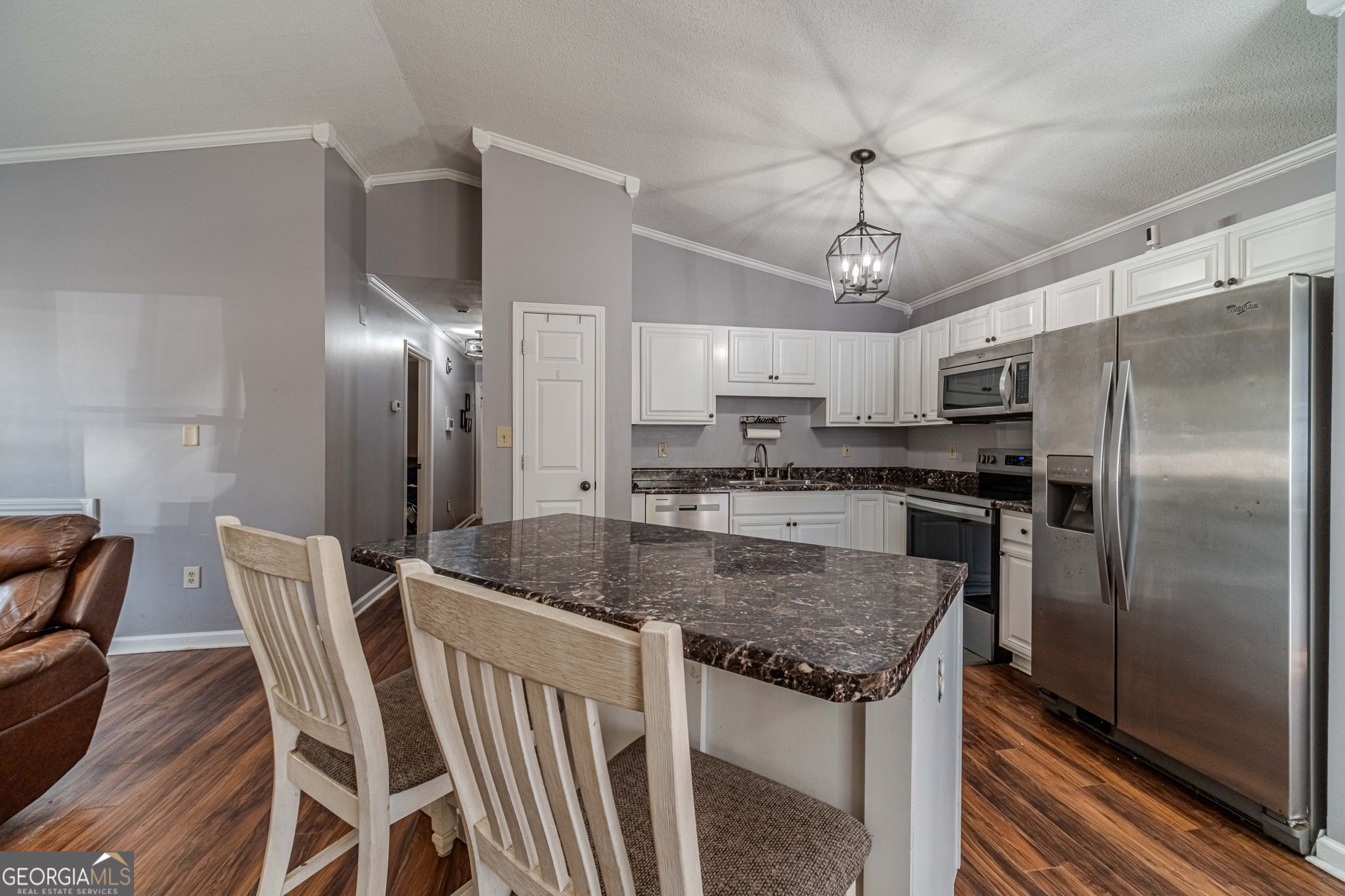 2811 High Shoals Road Good Hope, GA 30641 - Photo 8 of 37 a kitchen with stainless steel appliances granite countertop a sink a stove a refrigerator cabinets and chairs