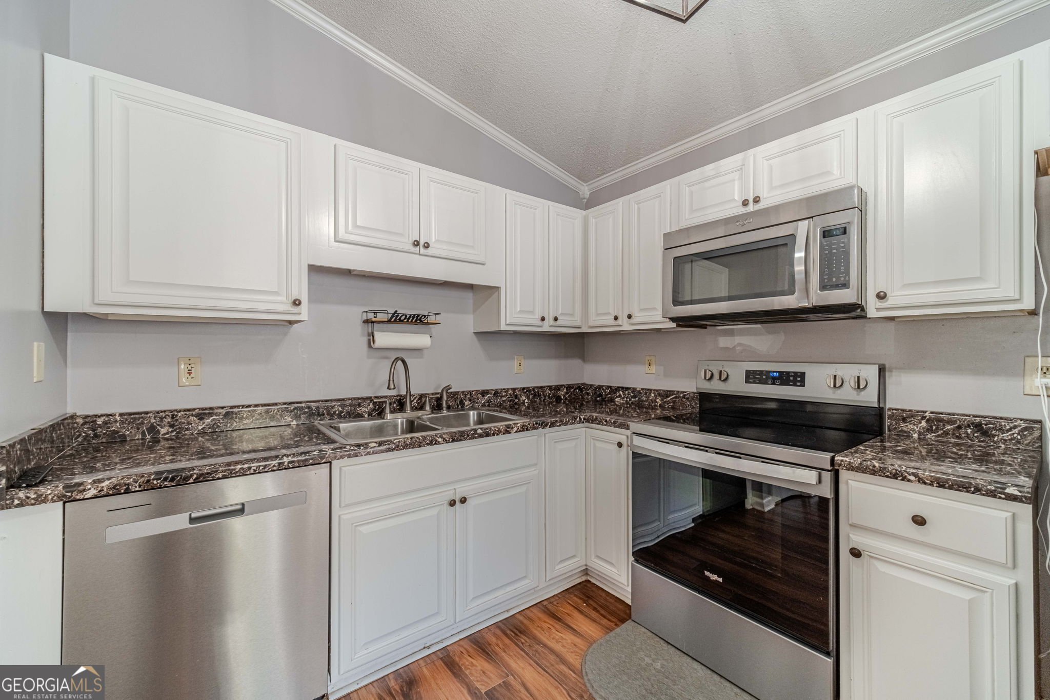 2811 High Shoals Road Good Hope, GA 30641 - Photo 10 of 37 a kitchen with granite countertop white cabinets and stainless steel appliances