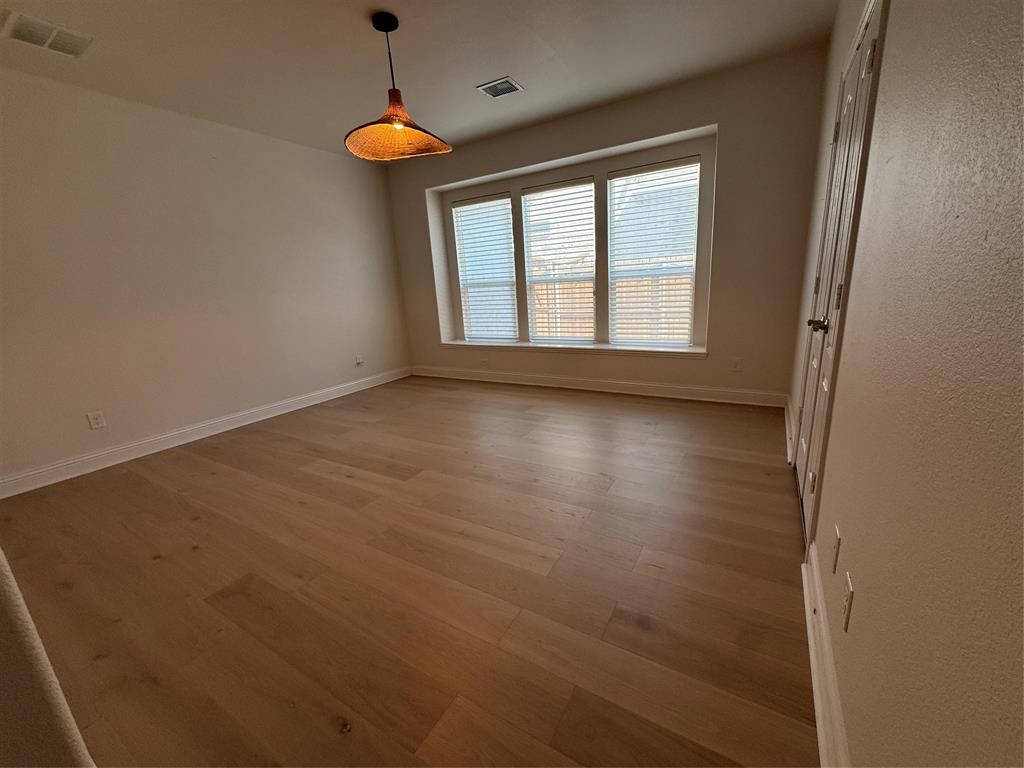 5212 Troupe Road McKinney, TX 75071 - Photo 11 of 40 a view of room with window and wooden floor