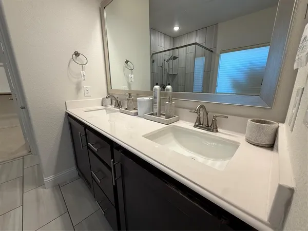 a spacious bathroom with a tub sink and mirror