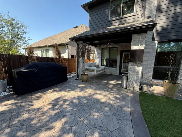 a view of a house with a yard and furniture