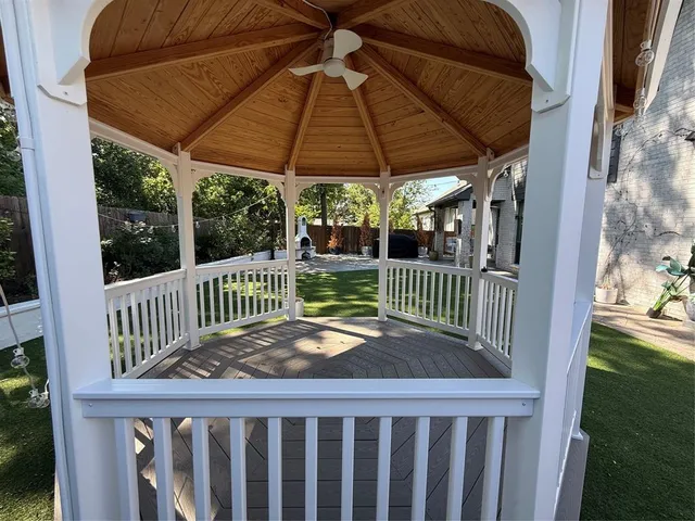 a view of a wooden deck with a small yard