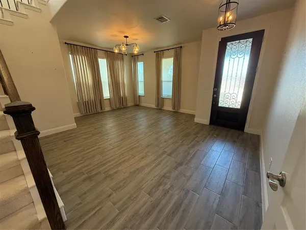 wooden floor in an empty room with a mirror