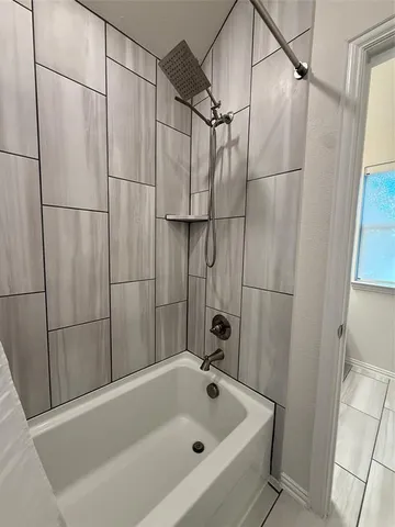 a bathroom with a bathtub and a shower