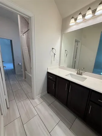 a bathroom with a double vanity sink and mirror