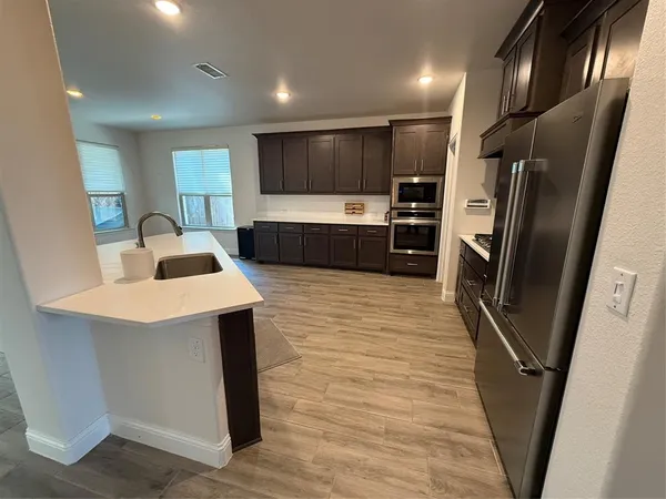 a kitchen with stainless steel appliances a refrigerator and a sink