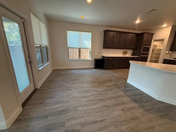a view of an empty room with glass door and balcony