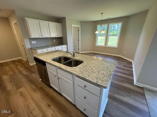a kitchen with sink and cabinets