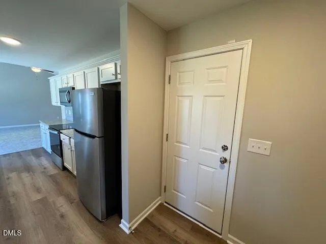 a view of a refrigerator in kitchen and wooden floor