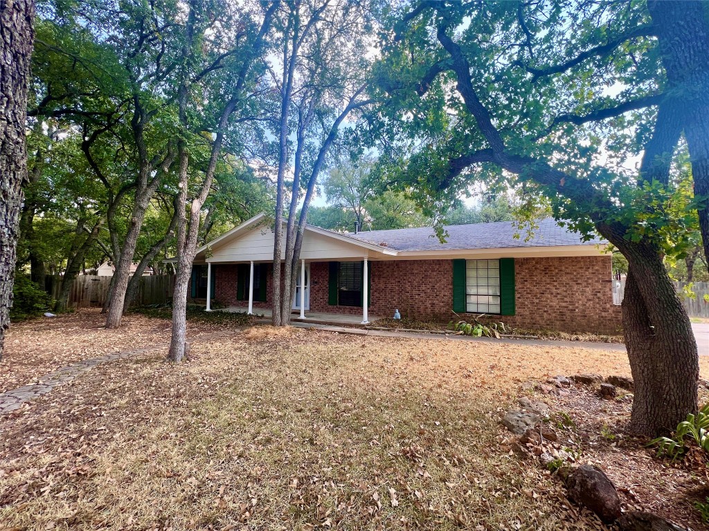 2607 Robin Road Manchaca, TX 78652 - Photo 1 of 1 a tree in front of a white house