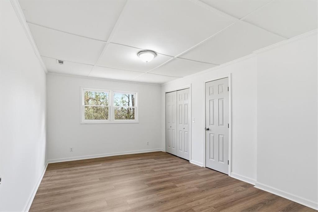 344 Colbert Road Dallas, GA 30132 - Photo 22 of 29 a view of an empty room with wooden floor